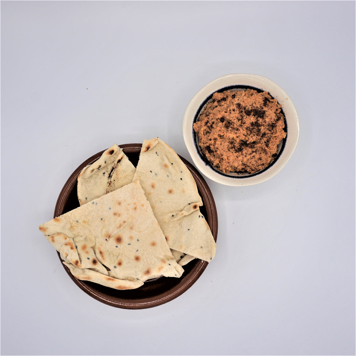 Homemade harissa hummus served with flatbreads – Hill & Vale